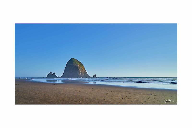 Haystack Rock glows in the late day sun at Cannon Beach, OR